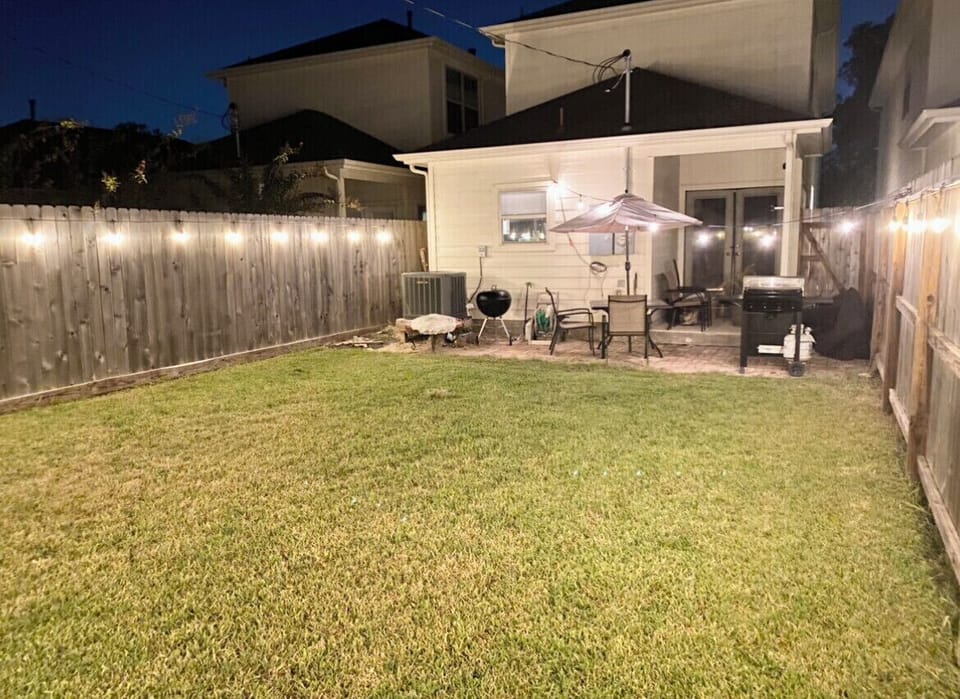 Fully fenced in backyard with lights to brighten up the area! 