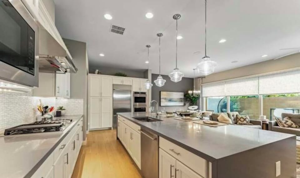 Fully stocked kitchen gas cooktop with griddle, double oven.