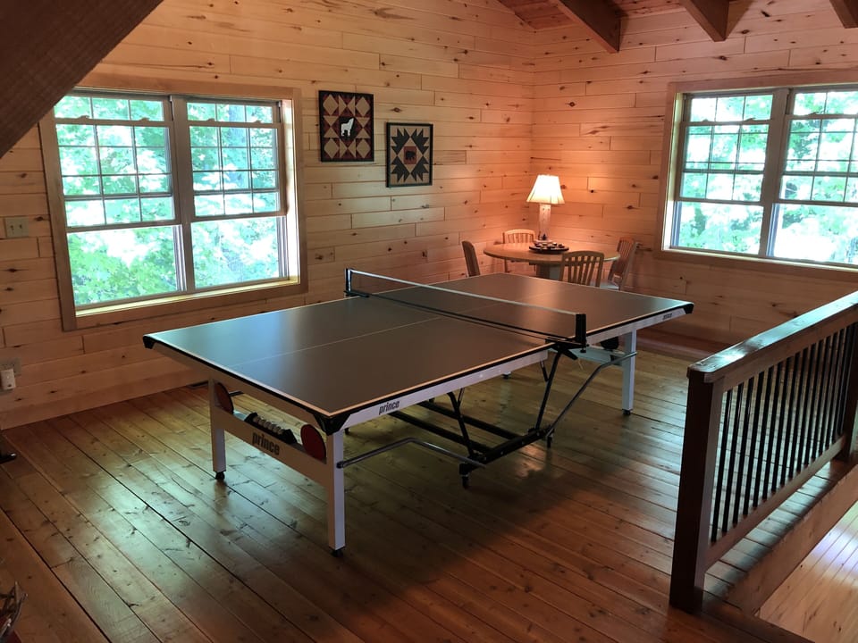 Loft room featuring a ping pong table and game table