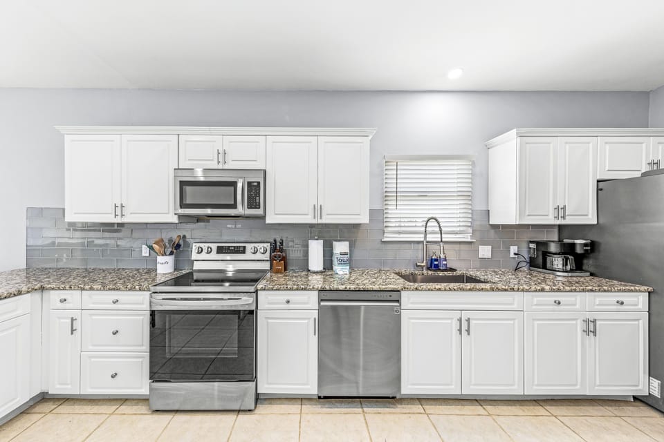 Fully equipped, granite countertops, L-shaped center-island bar, stainless steel appliances, Keurig with K-cups, drip coffeemaker, toaster, blender, spices and other cooking essentials