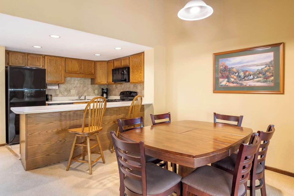 Gather by the stone fireplace under soaring, cabin-style ceilings.