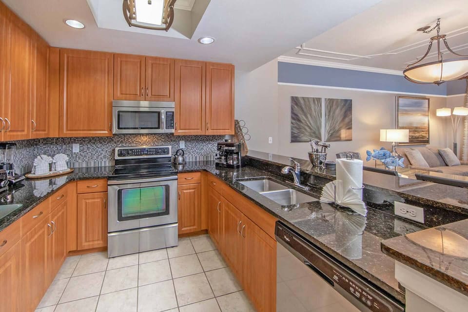 Signature stainless steel appliances and granite counter tops in the kitchen.