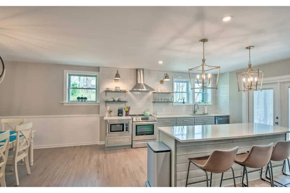 Kitchen with 4 chairs at island, 12 pot coffee maker, keurig and cooking spices 