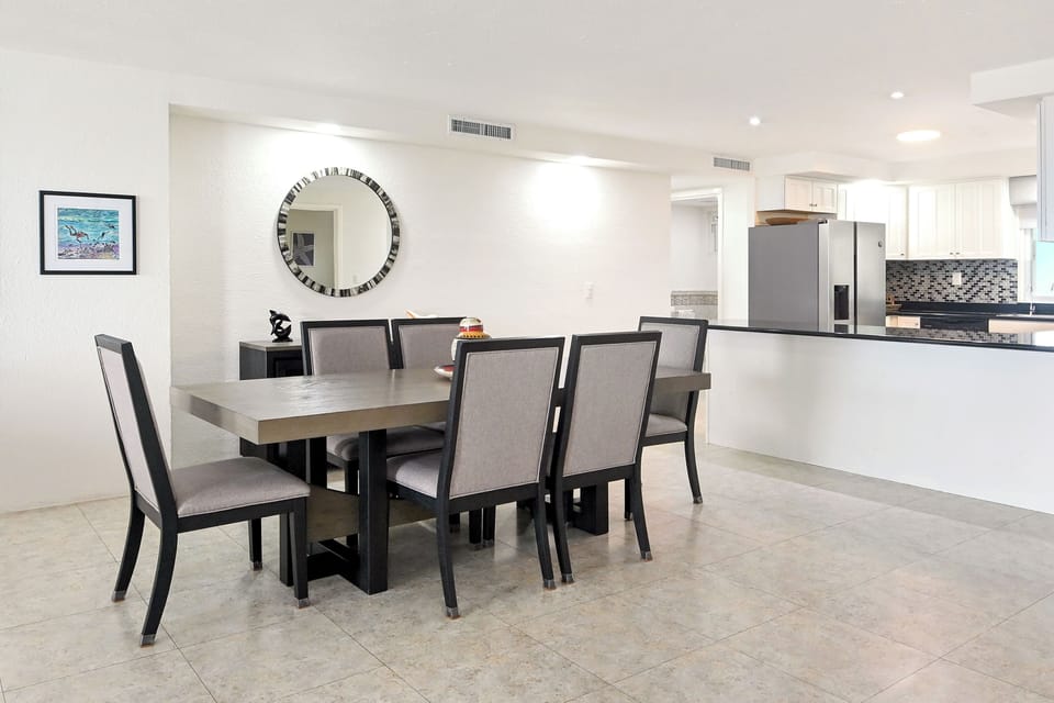 Your elegant dining space flows seamlessly into a modern kitchen, perfect for memorable meals with family and friends.