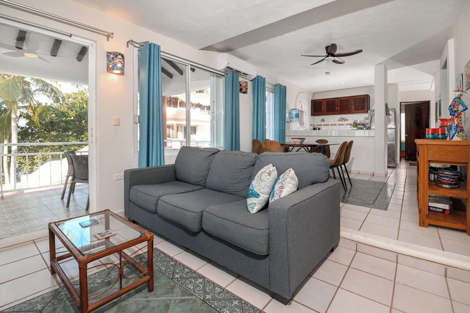 Your bright, open-concept living space features comfortable seating and flows seamlessly to the dining area and kitchen, perfect for relaxing after tropical adventures.