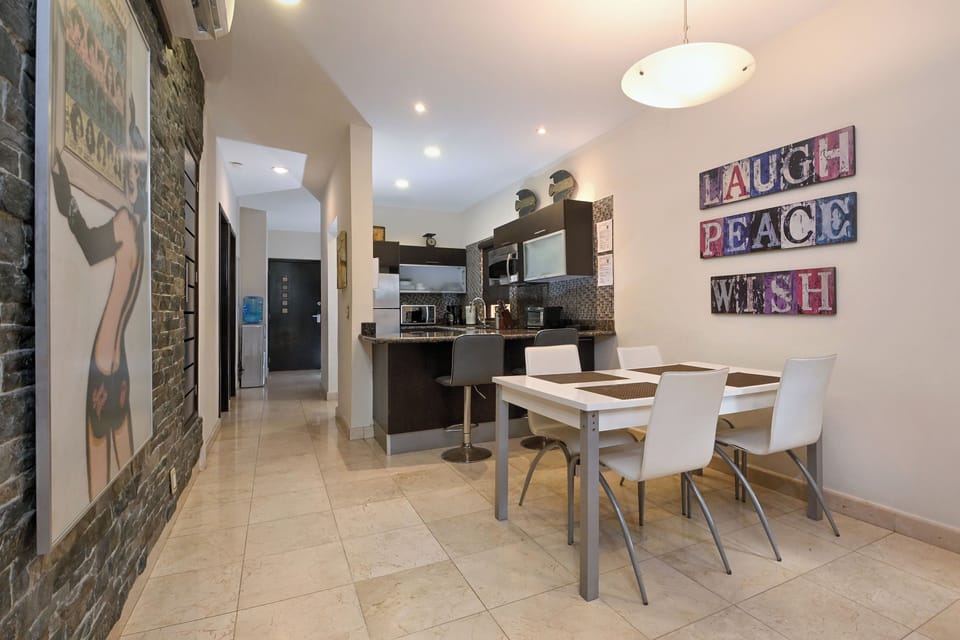 Your open-concept dining area invites you to enjoy meals together in bright, cheerful surroundings. Vibrant wall art and a welcoming layout make every breakfast feel special.