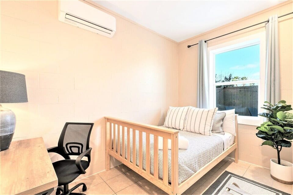 Fifth bedroom, the Outcast Cave, off the garage, with a private focus area with a full size bed