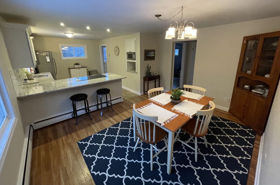 Updated kitchen with granite counter top and dining room table for four