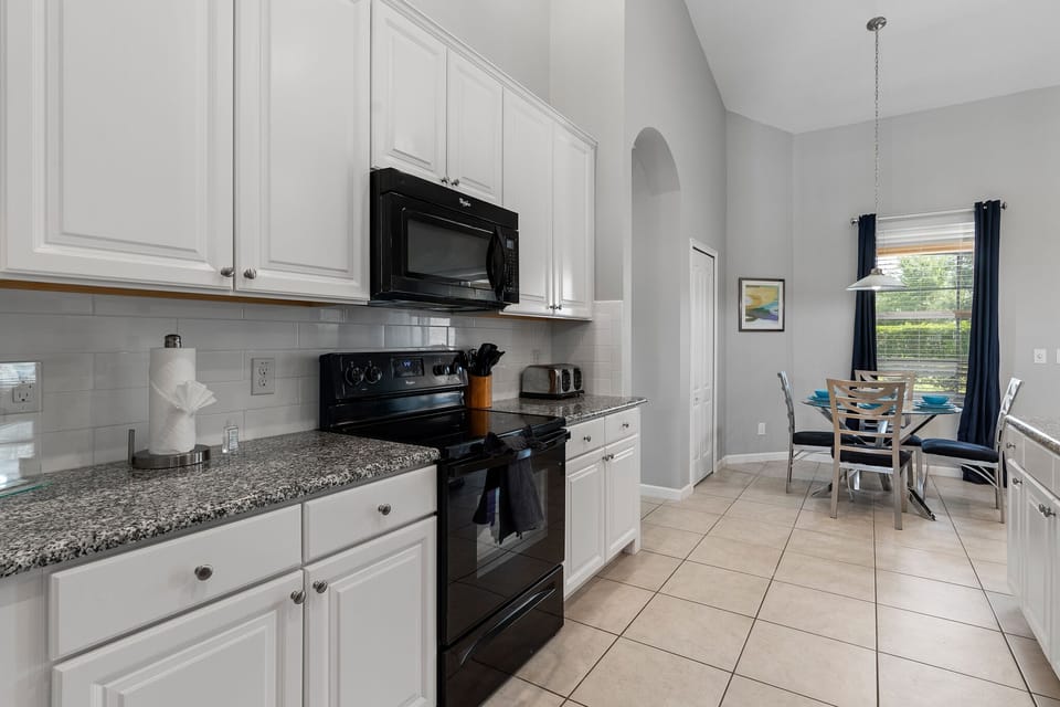 Kitchen.  Microwave, electric range and oven.  Toaster, and coffee makers & more