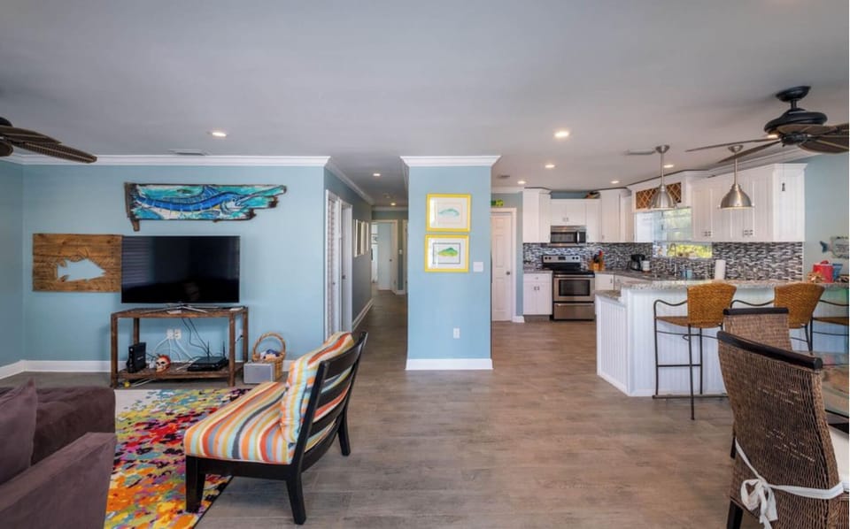 Living room & Kitchen.  Hallway leads to 3 bedrooms and 3 bathrooms.
