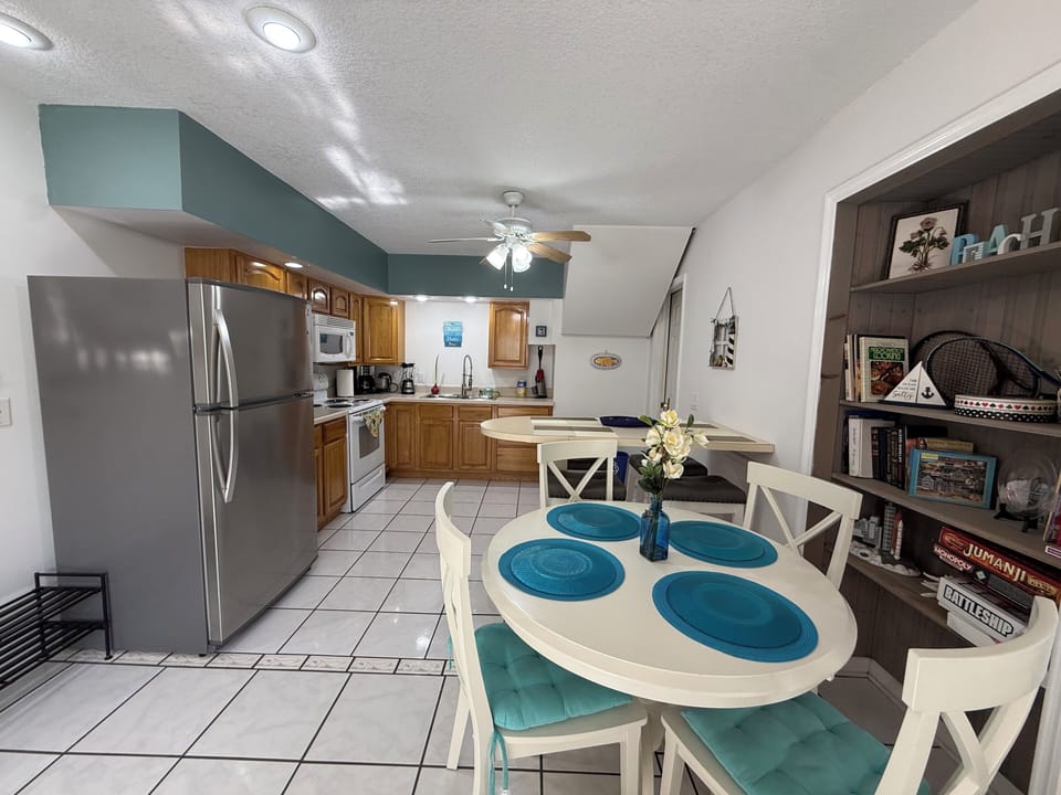 Full kitchen with cookware, utensils, microwave, stove, oven & full-size fridge