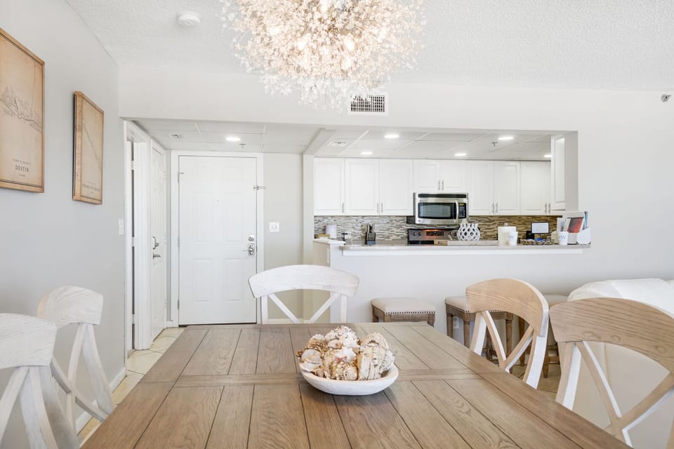 You'll love gathering around this beautiful dining table under the sparkling chandelier, with your fully equipped kitchen just steps away.