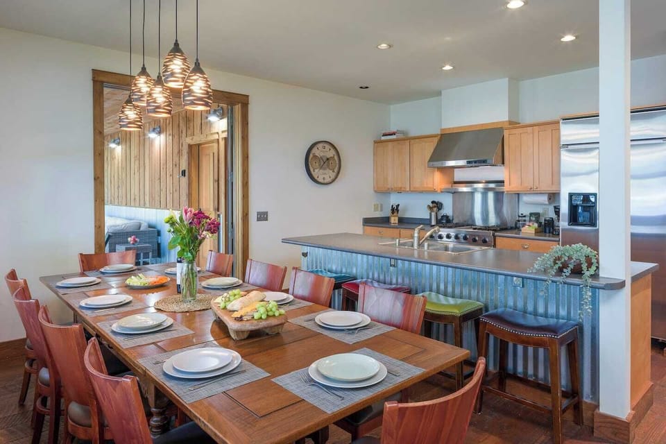 The dining and kitchen areas are connected and feature a door that opens to a patio, allowing you to seamlessly enjoy the beautiful outdoor views.