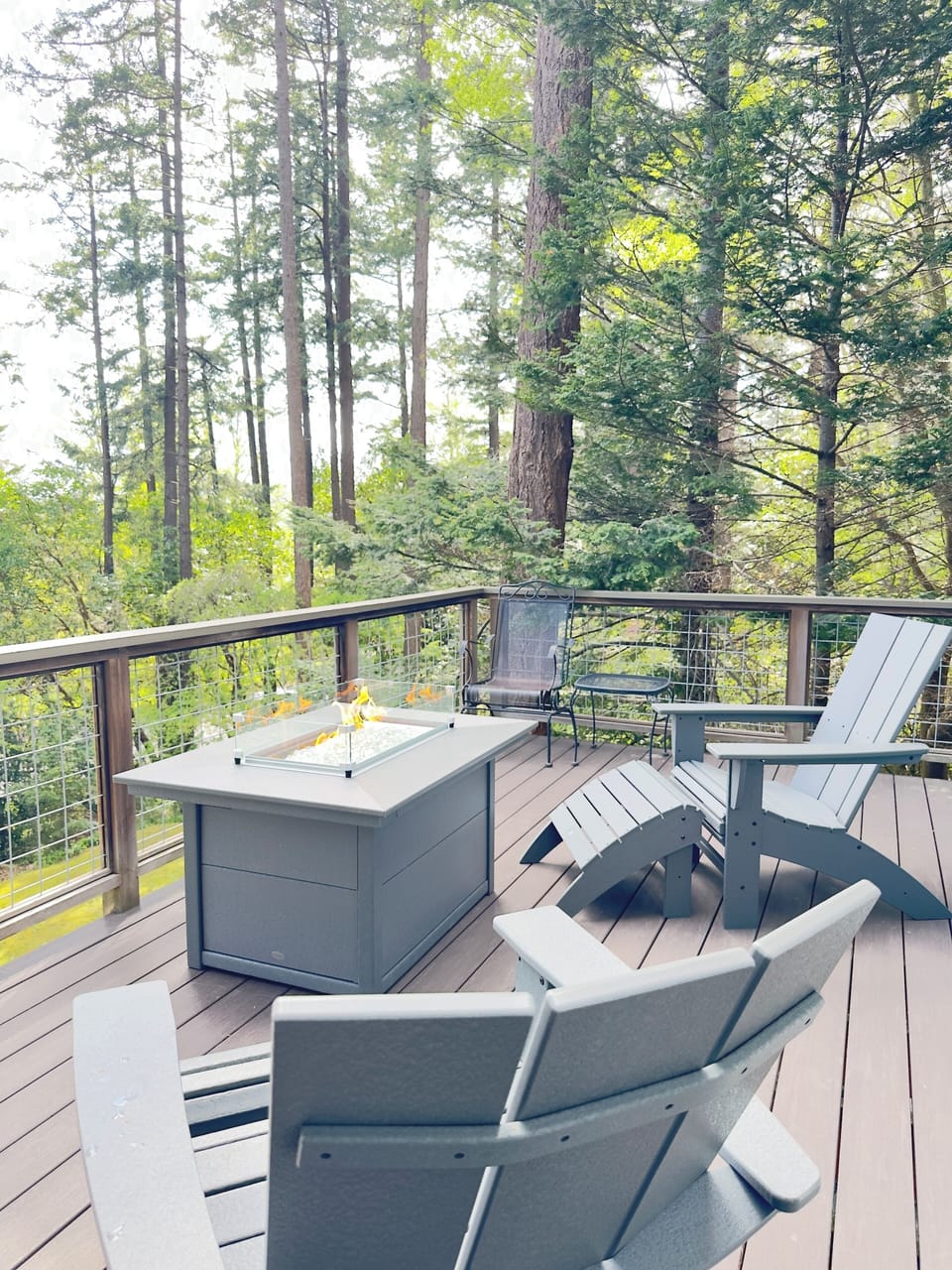 Comfortable Adirondack chairs and ottoman allow for early morning and evening relaxation.