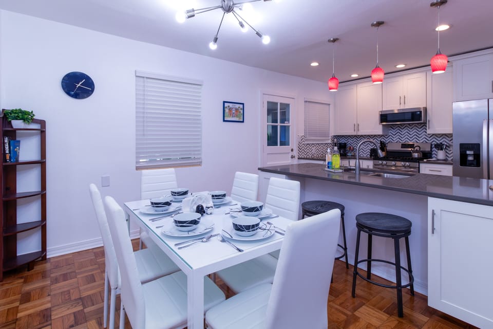 Dining room table seats six, with room for two more to eat at the breakfast bar