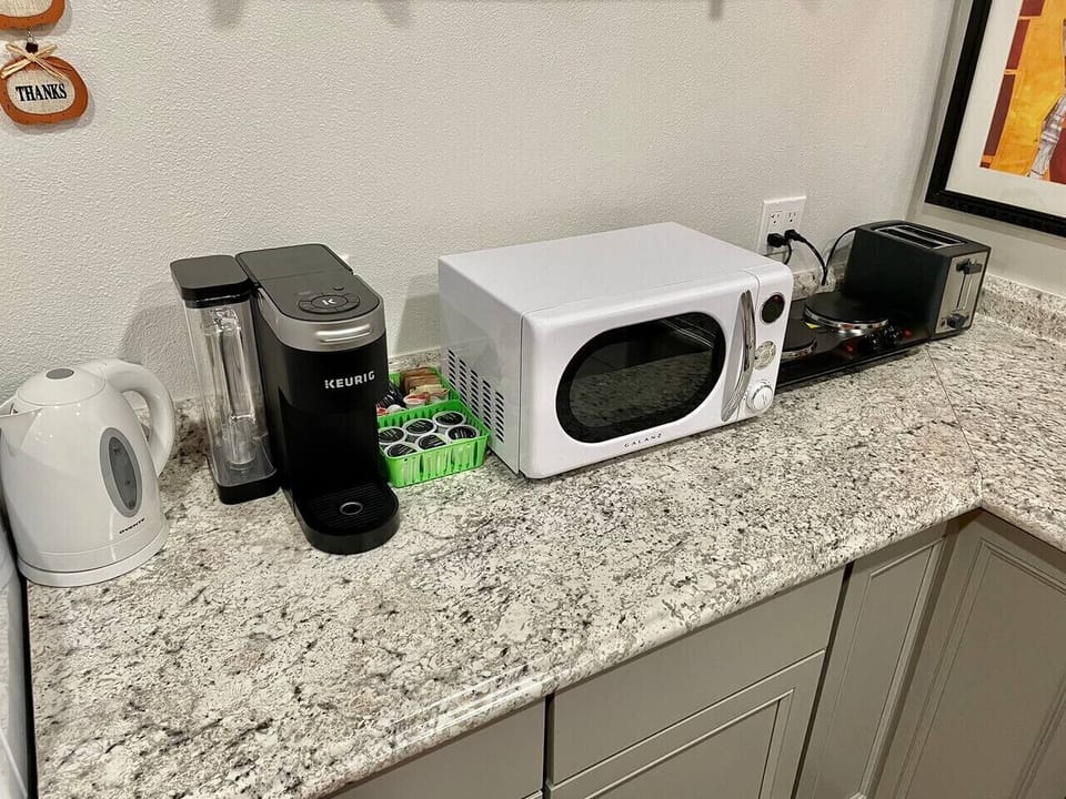 Kitchen with kettle, Keurig, microwave, 2 burner hot plate, toaster