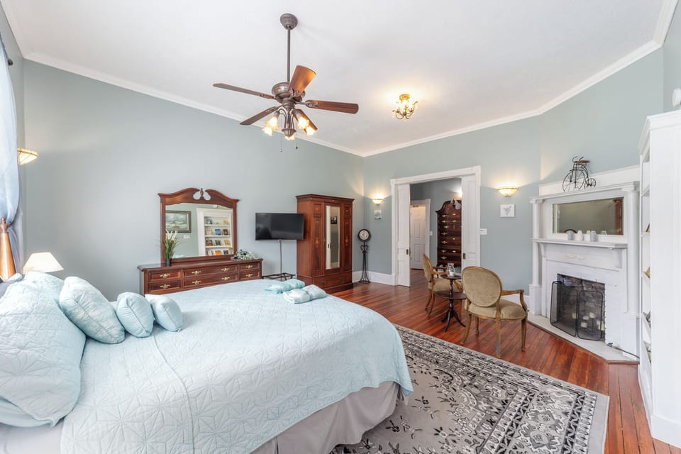 Bedroom with King Sized bed, decorative fireplace, and Smart TV