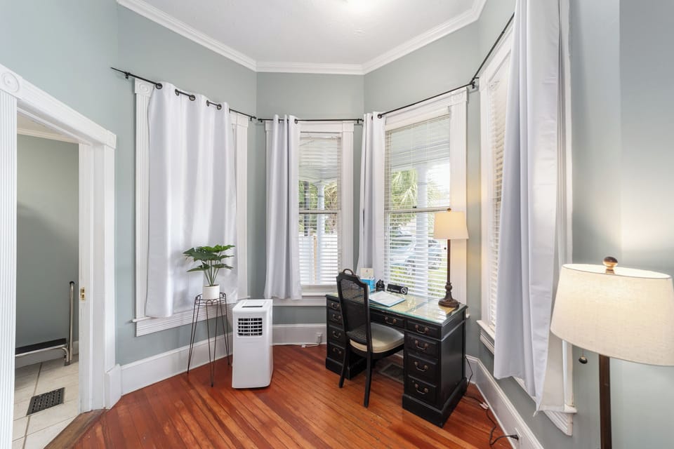 Bedroom with queen sized bed, closet, fireplace, smart tv, sitting area, desk