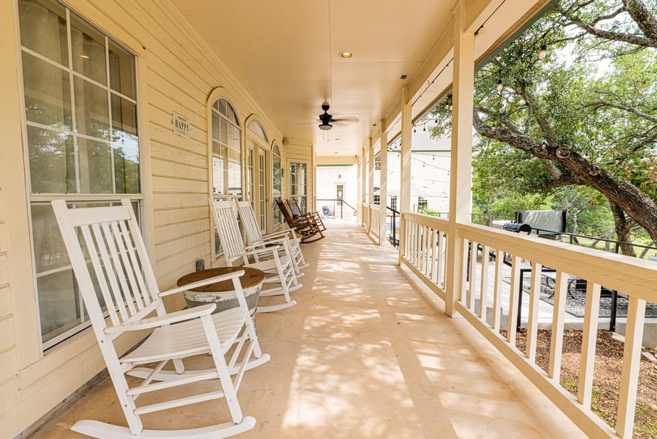 Large covered porch with seating and fans