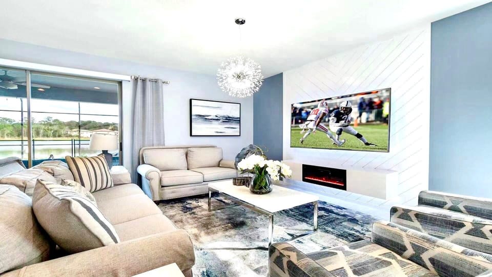 Features a large screen TV and cozy couches, providing a comfortable and inviting setting for relaxation and entertainment