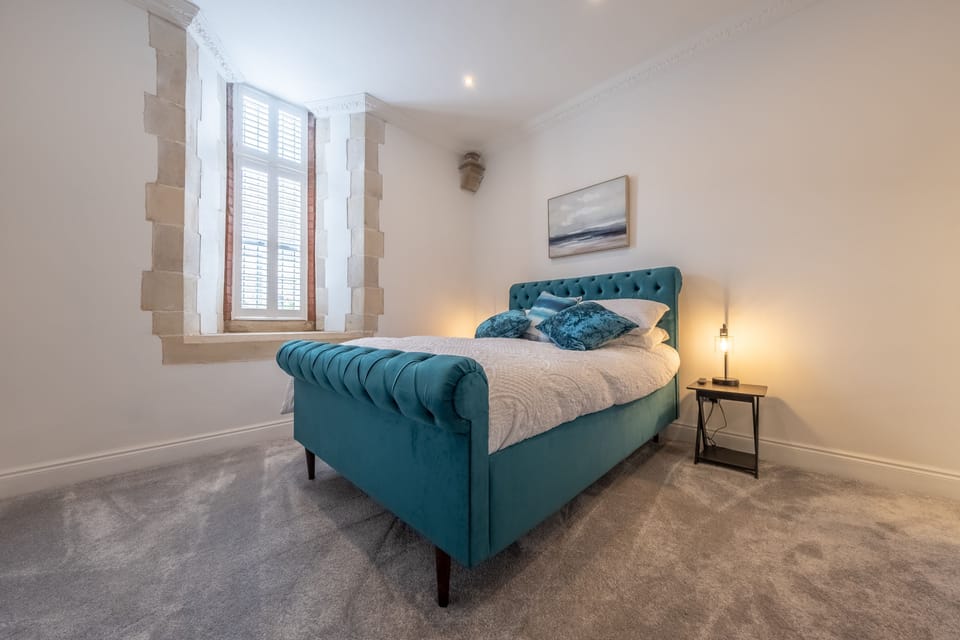 Ground floor: Bedroom five with king-size bed