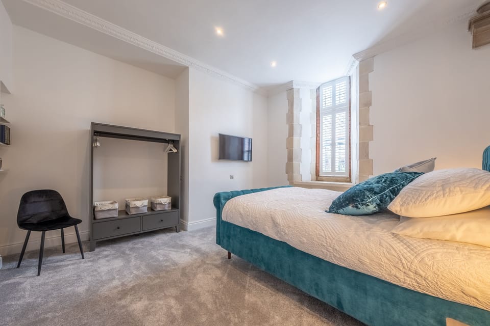 Ground floor: Bedroom five with king-size bed