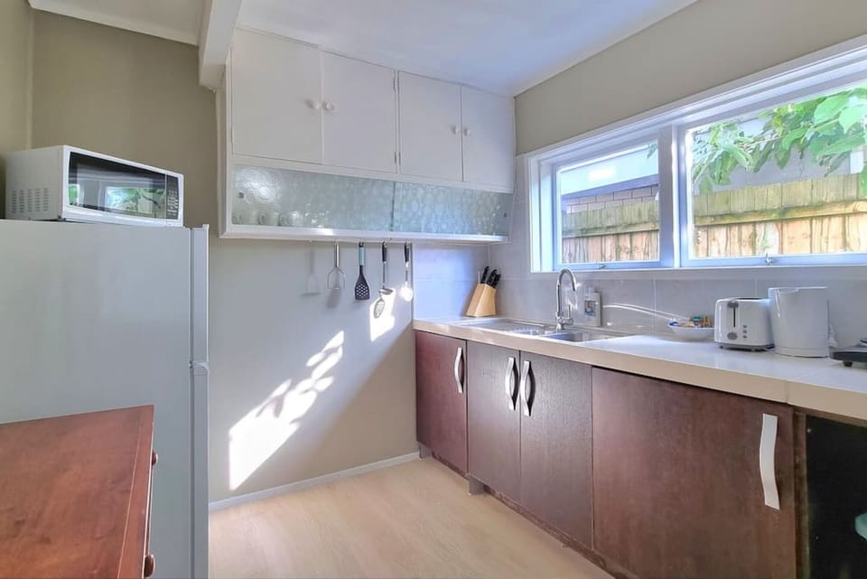 The kitchenette has a portable cooktop, microwave, toaster and fridge/freezer.