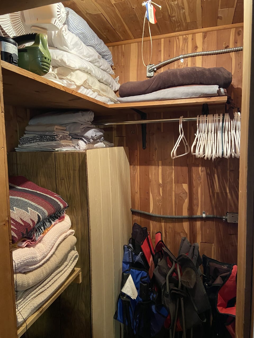 Linen closet in bedroom 2, with extra linens, camping chairs.