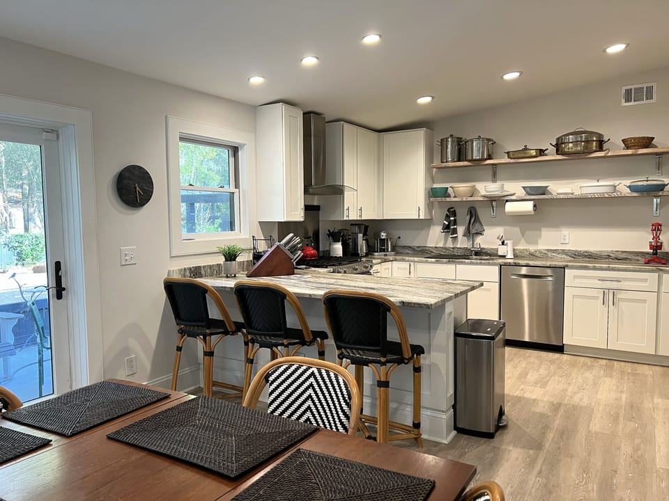Great kitchen, with a bar for extra seating, and access to patio.