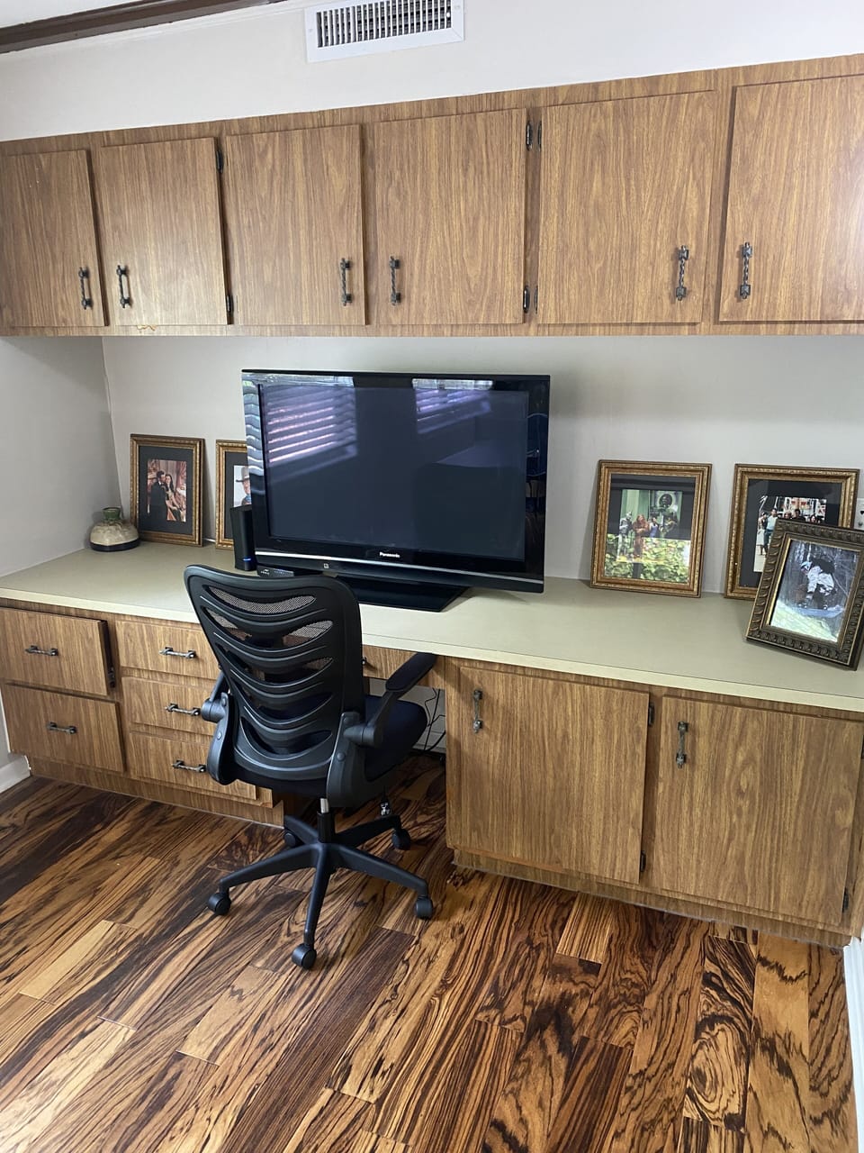 Desk with large computer monitor.  Just a monitor. 