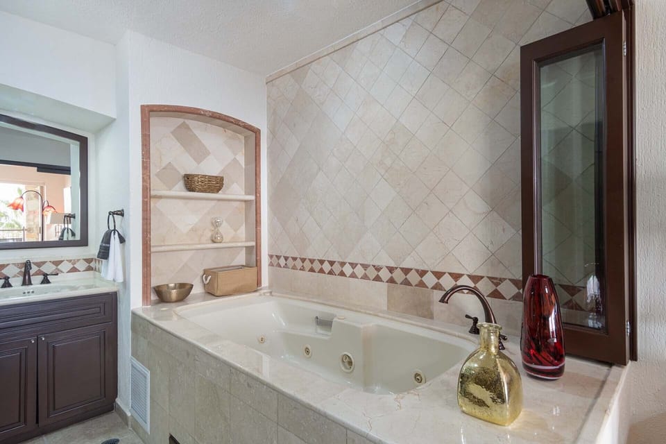 The main bedroom has its own tub. along with a shower and double vanity