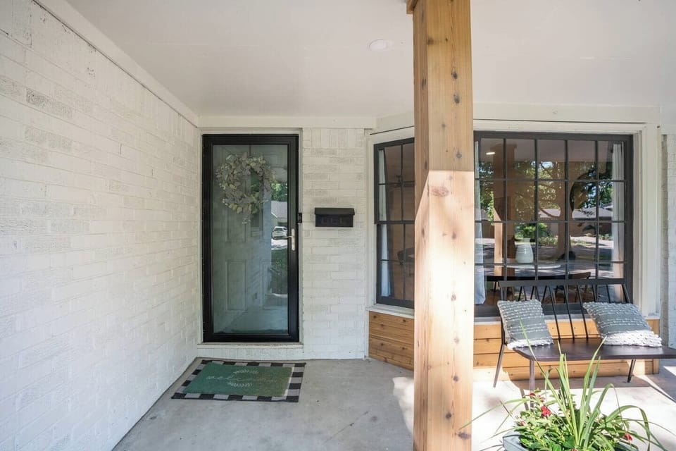 Beautiful Front porch with white brick and cedar columns.  Enjoy sitting on the bench in front of the Bay Window.  