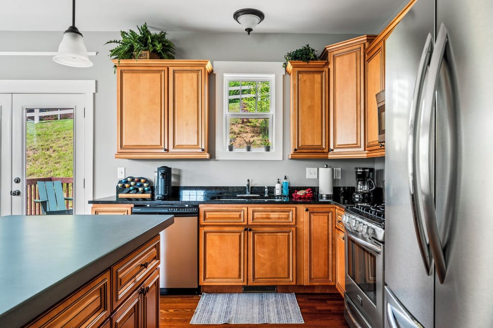 Well stocked kitchen with expanded concrete kitchen island.