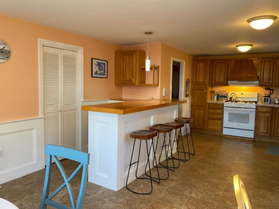 Bar with seating for 4.  Washer/Dryer located behind louver doors.  