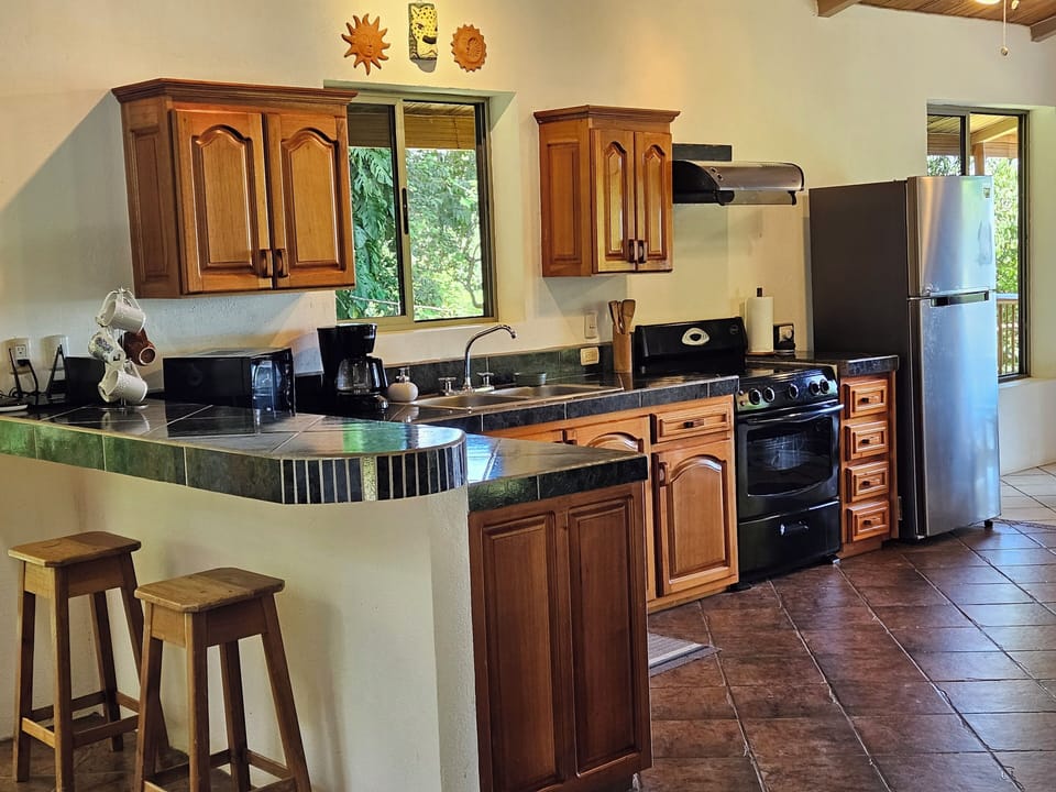 Fully equipped and spacious kitchen with bar top area.