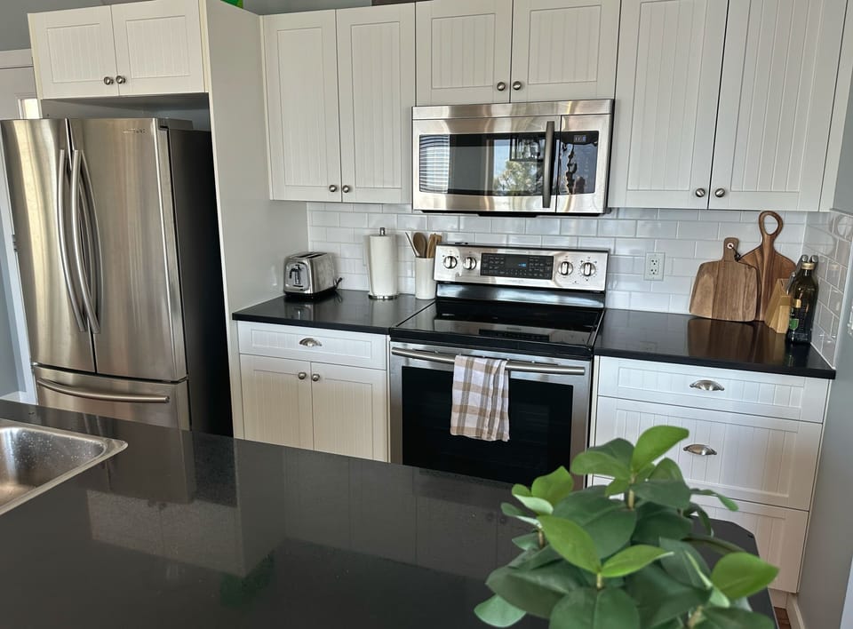 Well designed and open floor plan kitchen area makes visiting while cooking easy