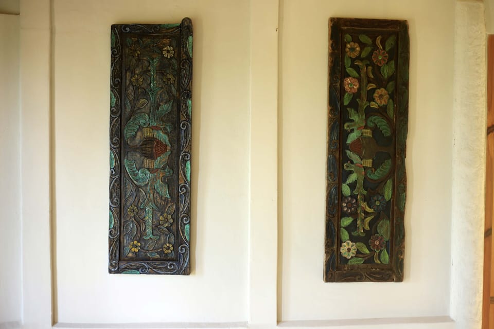 Hand-carved antique door panels adorn the walls of the great room
