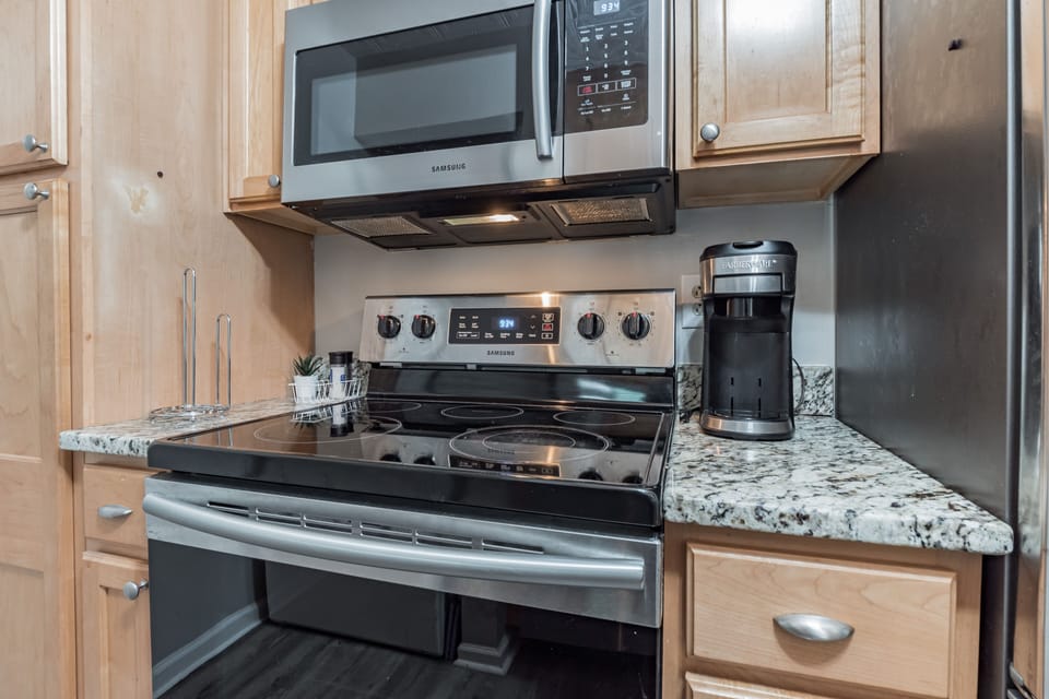 Kitchen, with stove and microwave, all cooking pots and pans and utensils