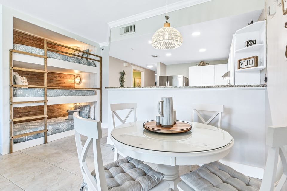 Seating for four at the table with views of the TV and pool. 