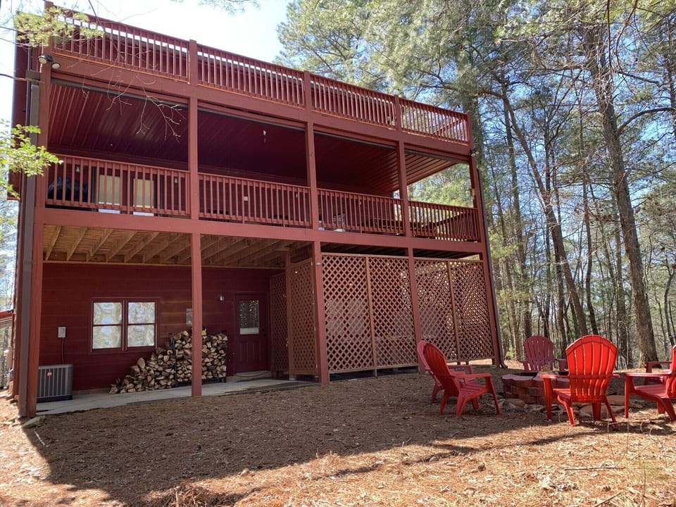 Back of house photo with hottub, firpit, 2 large porches