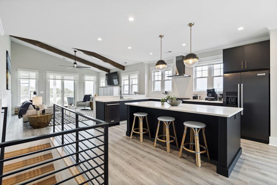 Fully equipped kitchen with island seating and charging station.