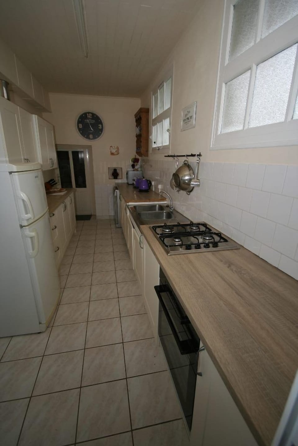 Galley kitchen with gas hob, electric oven and dishwasher