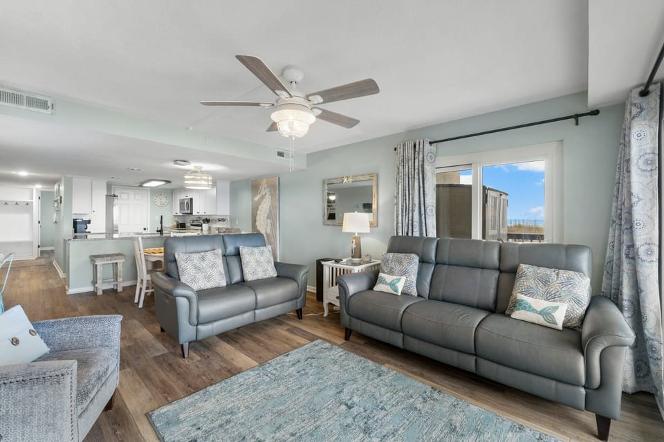 Living room with leather reclining sofa and loveseat.