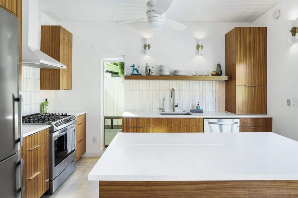 Bright and modern kitchen with sleek wood cabinetry, quartz countertops, and stainless steel appliances — fully equipped for everything from morning coffee to gourmet dinners.