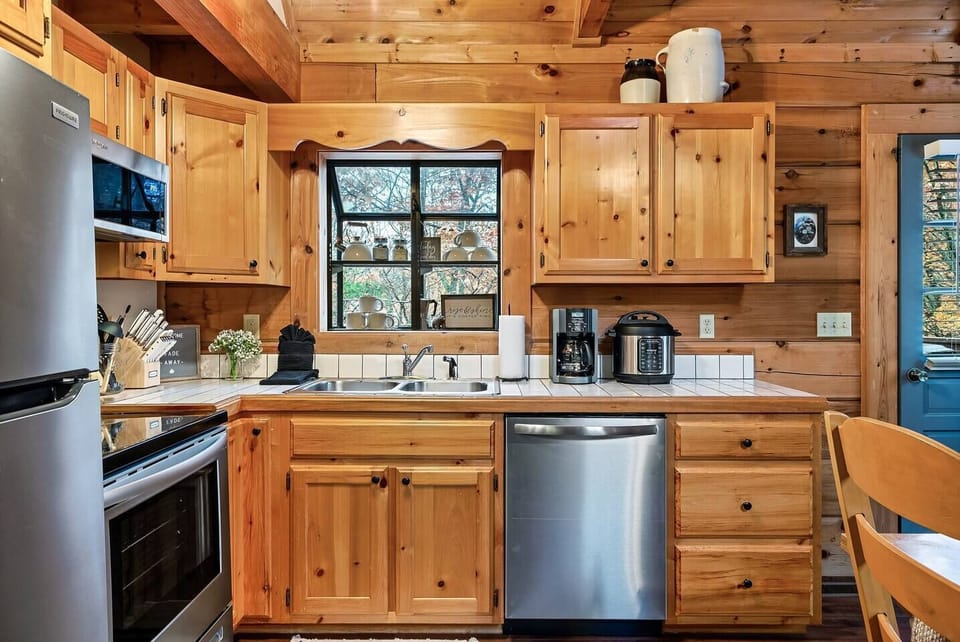 Full kitchen with tile counters and backsplash.