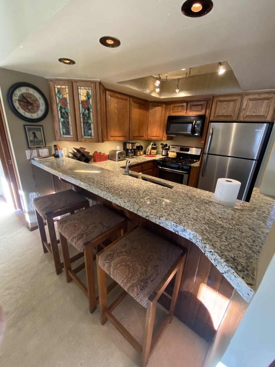 Kitchen has pass thru breakfast bar with seating for 3.