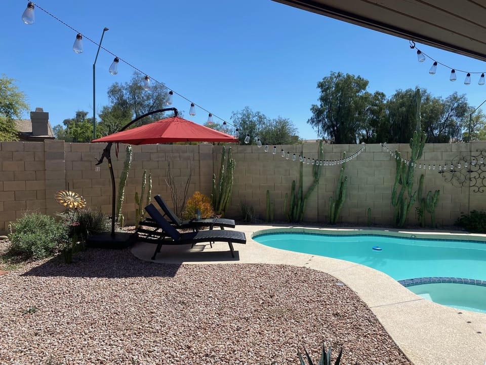 Pool lounge chairs with large umbrella 