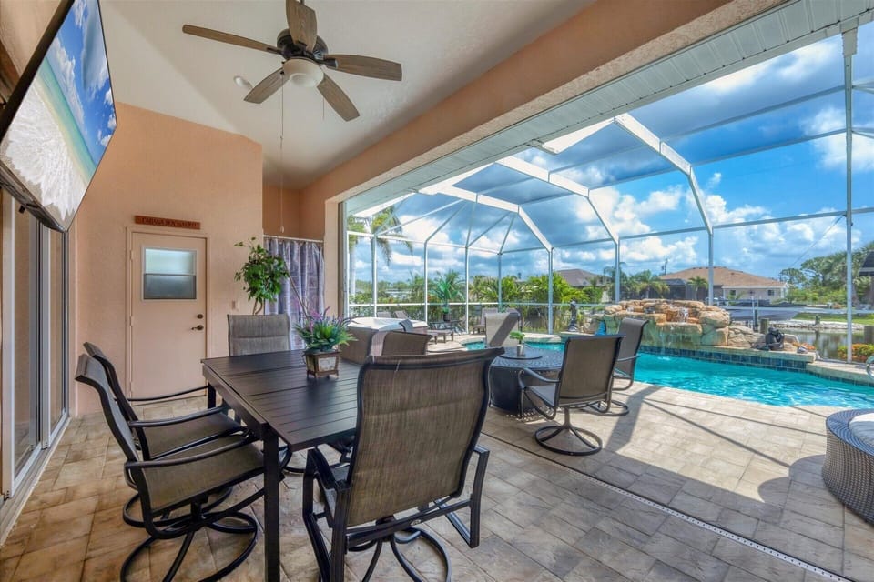 Outdoor dining on the lanai overlooking the sparkling pool & canal