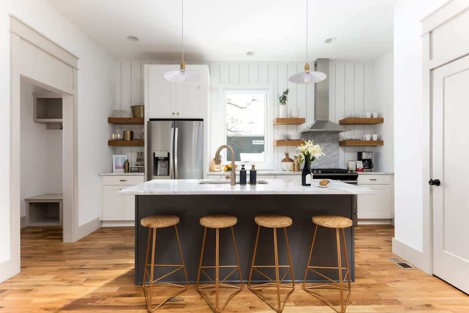 "The kitchen's open layout encourages socializing while preparing gourmet meals with upgraded stainless steel appliances.