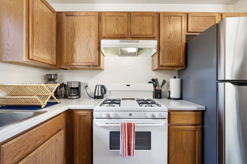 Another view of the kitchen with plenty of counter space and a full-size refrigerator.